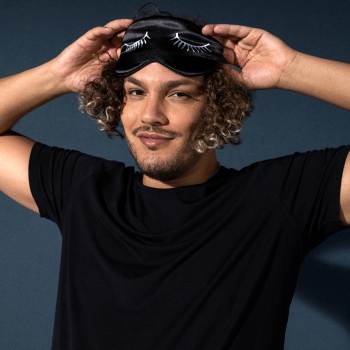 Man in black shirt with eye mask on top of head