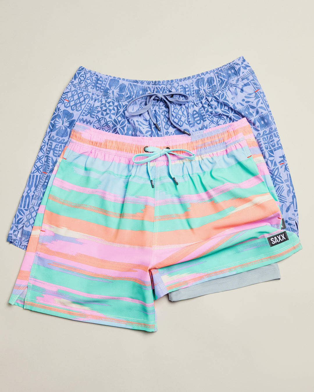 Pair of colorful shorts with a patterned waistband on a light gray background