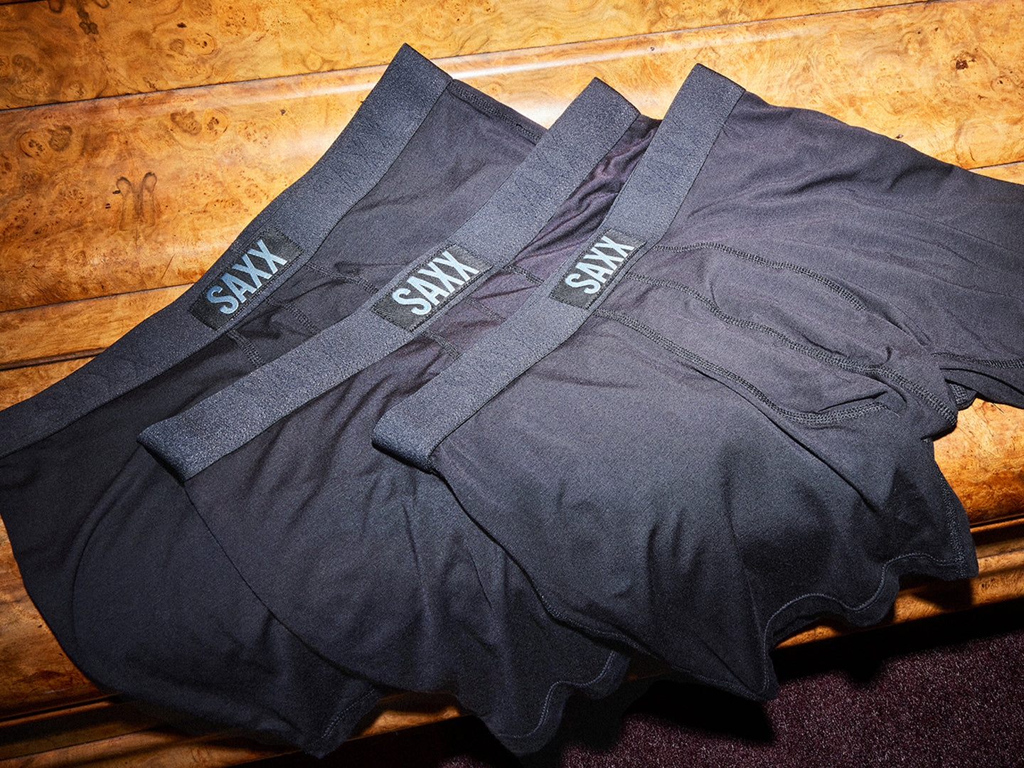 Black SAXX underwear on a wooden surface