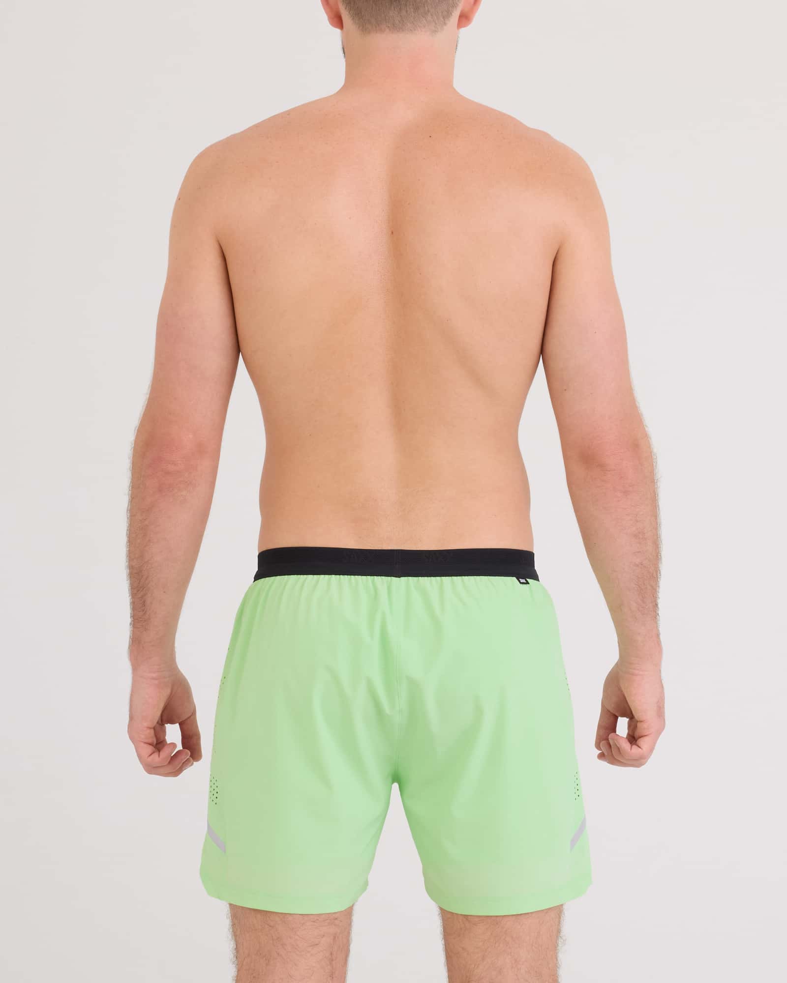 Back - Model wearing Run For All 2N1 Short 5" in Patina Green