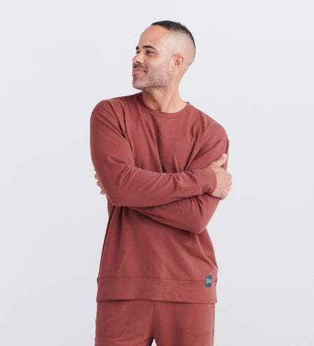 Man wearing a red sweatshirt and sweatpants