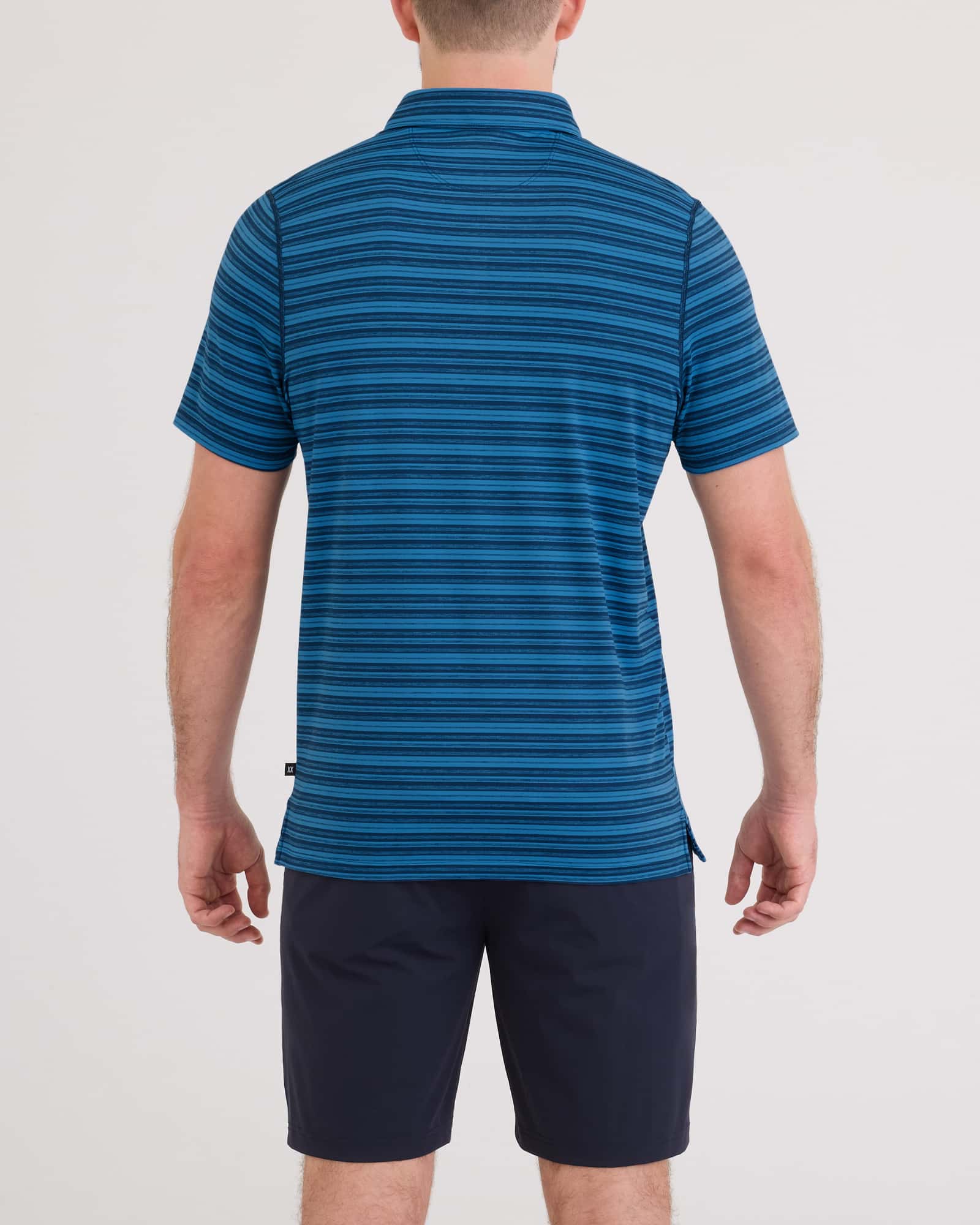 Back - Model wearing Droptemp All Day Cooling Polo in Dark Denim Stripe