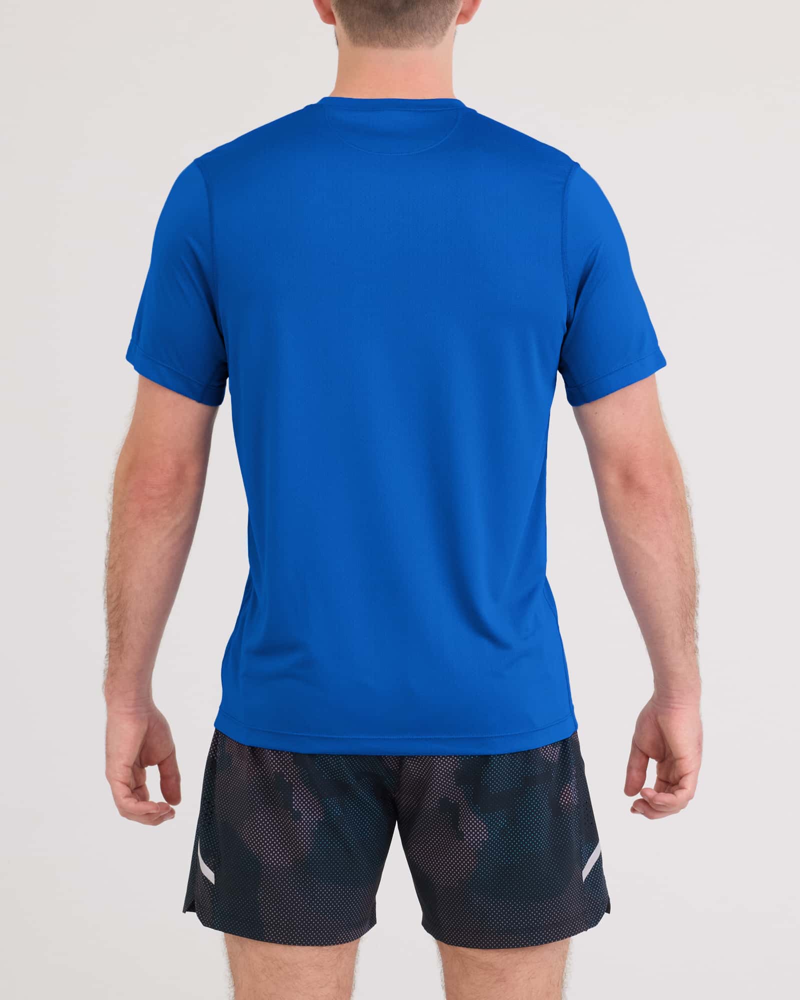 Back - Model wearing Multi-Sport Tech Tee in Bold Blue