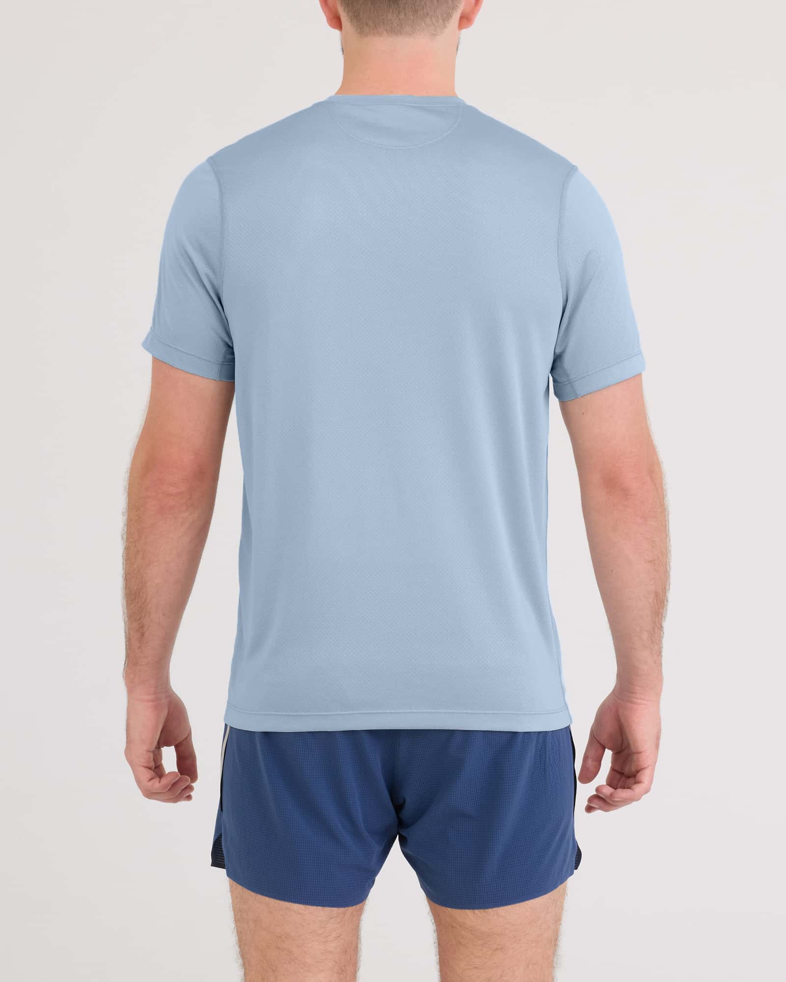 Back - Model wearing Multi-Sport Tech Tee in Blue Fog