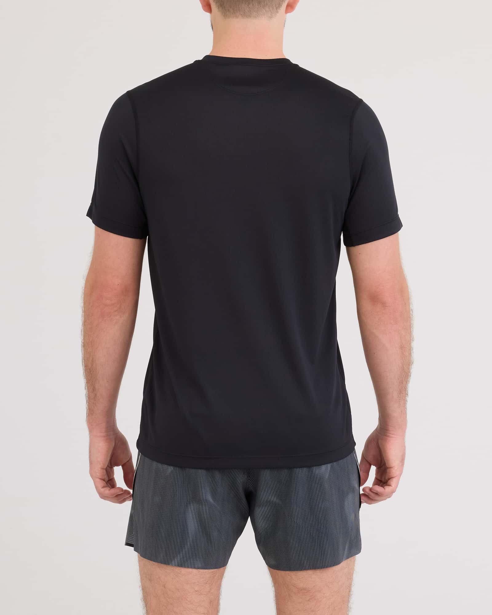 Back - Model wearing Multi-Sport Tech Tee in Black