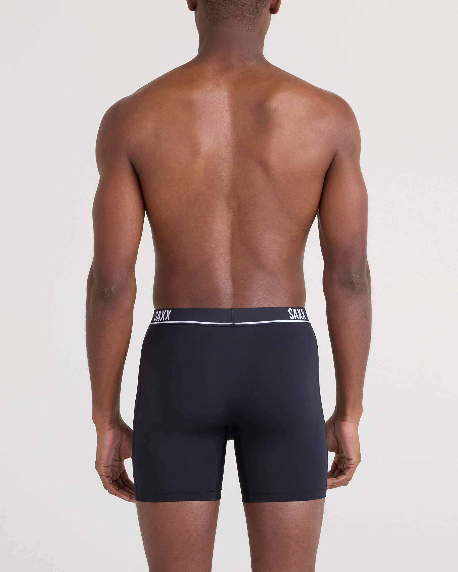 Back - Model posing in Essential Performance Mesh Boxer Brief in Black