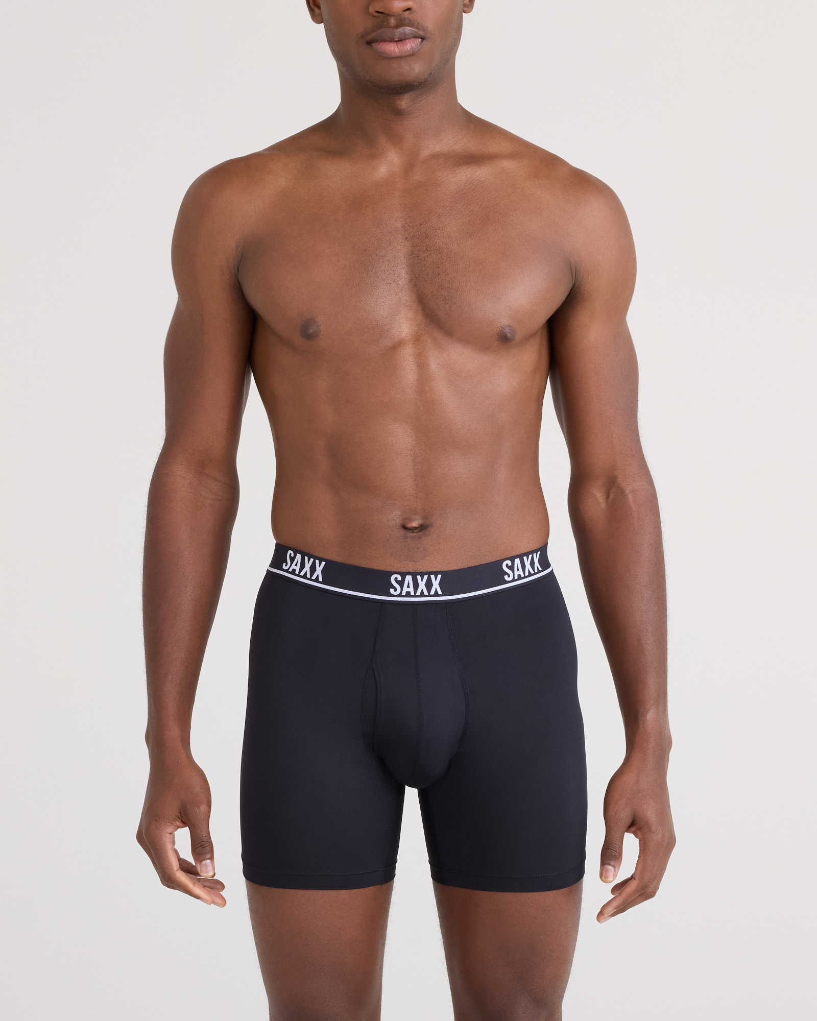 Front - Model posing in Essential Performance Mesh Boxer Brief in Black