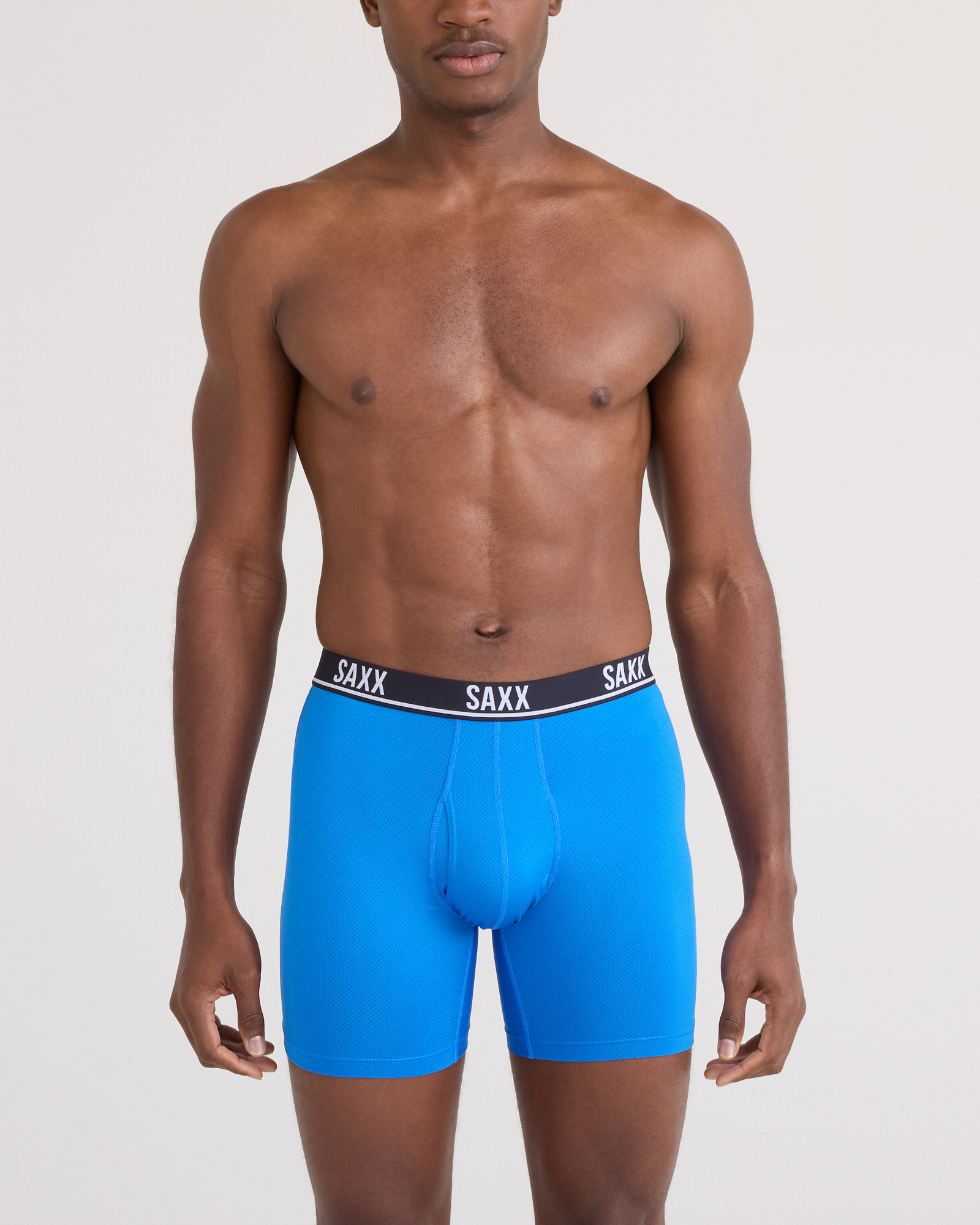 Front - Model posing in Essential Performance Mesh Boxer Brief in Blue/Teal/Maritime