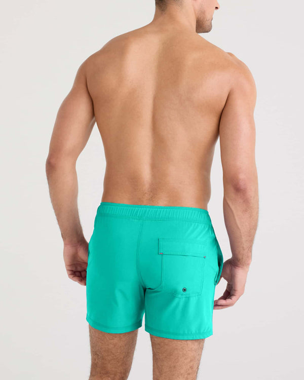 Back - Model wearing Oh Buoy 2N1 Swim Volley 5" in Peacock