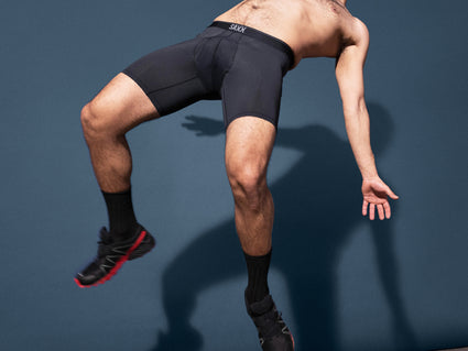 A person falling backwards, wearing Kinetic Light-Compression Mesh Long Leg Boxer Briefs