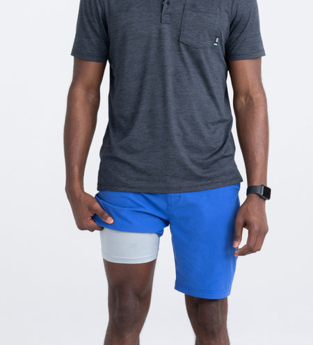 Man in blue shorts and grey shirt showing liner leg