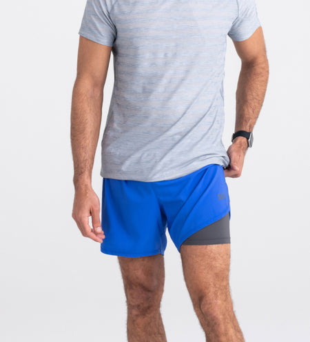 Man in blue shorts and short with liner leg exposed