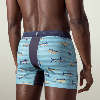 Shirtless man in fish patterned underwear standing with back turned