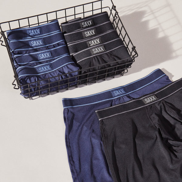 Ten pairs of blue and black boxer briefs in a wire basket