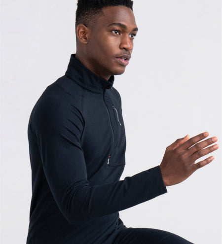 Man wearing black half zip long sleeve top