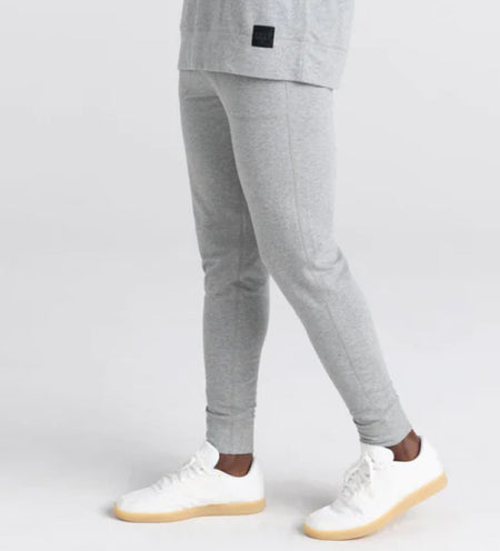 Man wearing gray sweatpants and white sneakers