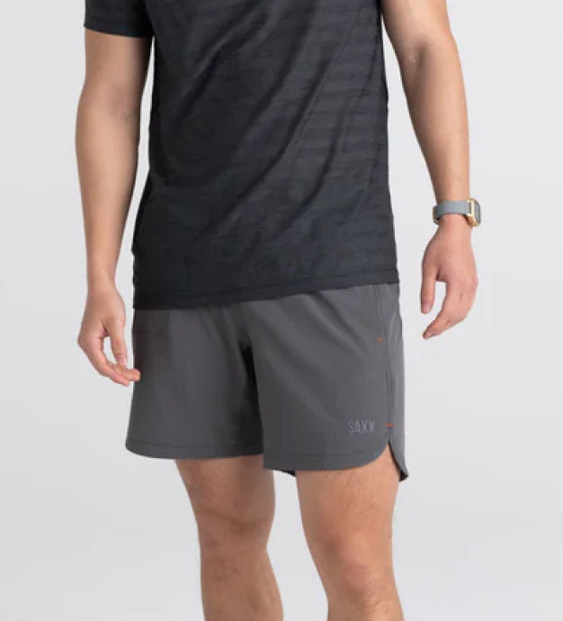 Man in dark gray shirt and light gray shorts with a liner