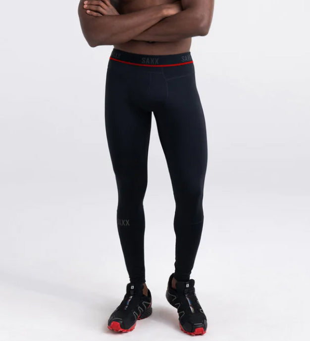 Man wearing black performance tights and black running shoes