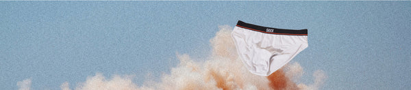 White pair of briefs with black waistband overtop of dust cloud and blue sky
