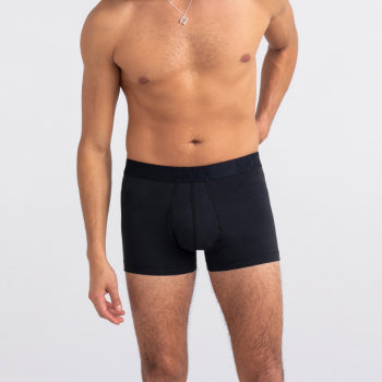 Shirtless man standing in black trunks