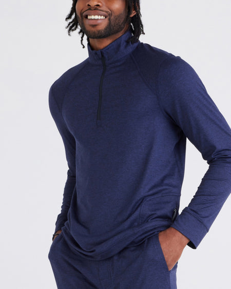 a man with dreadlocks wearing a blue shirt