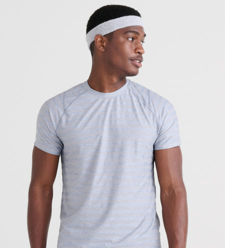 Man wearing matching headband and active tee in light gray