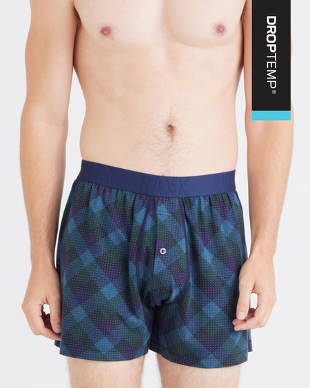 a man wearing a pair of blue and black plaid boxer shorts