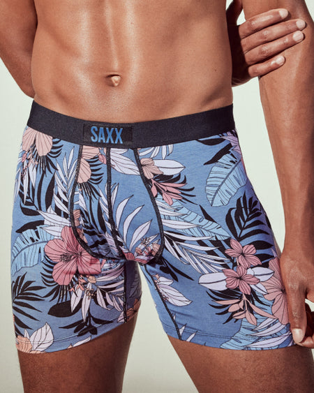 a man wearing a blue and pink floral boxer briefs