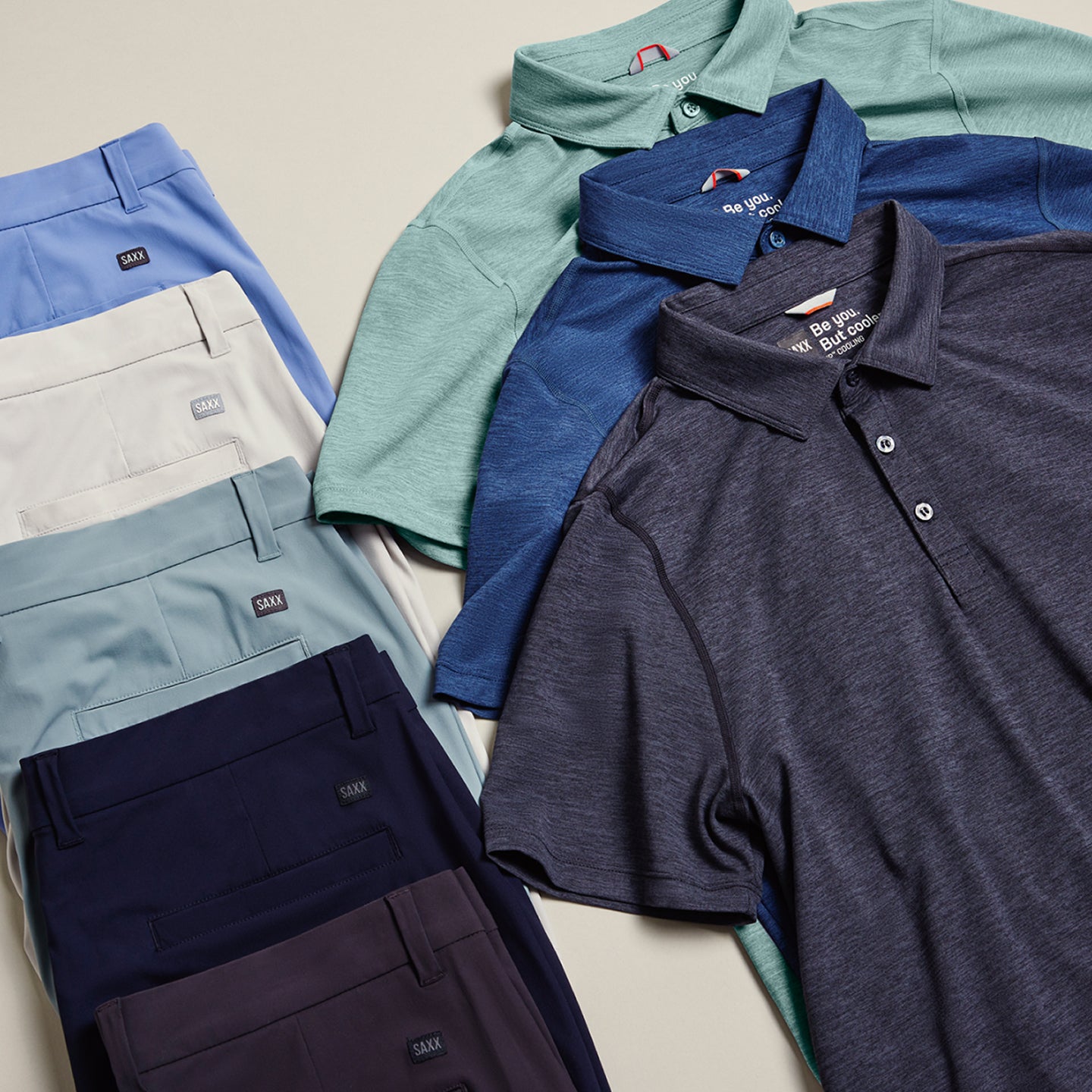 Five pairs of shorts and three polo shirts laid flat in rows. The row of shorts is to the left and the row of shirts to the left. 