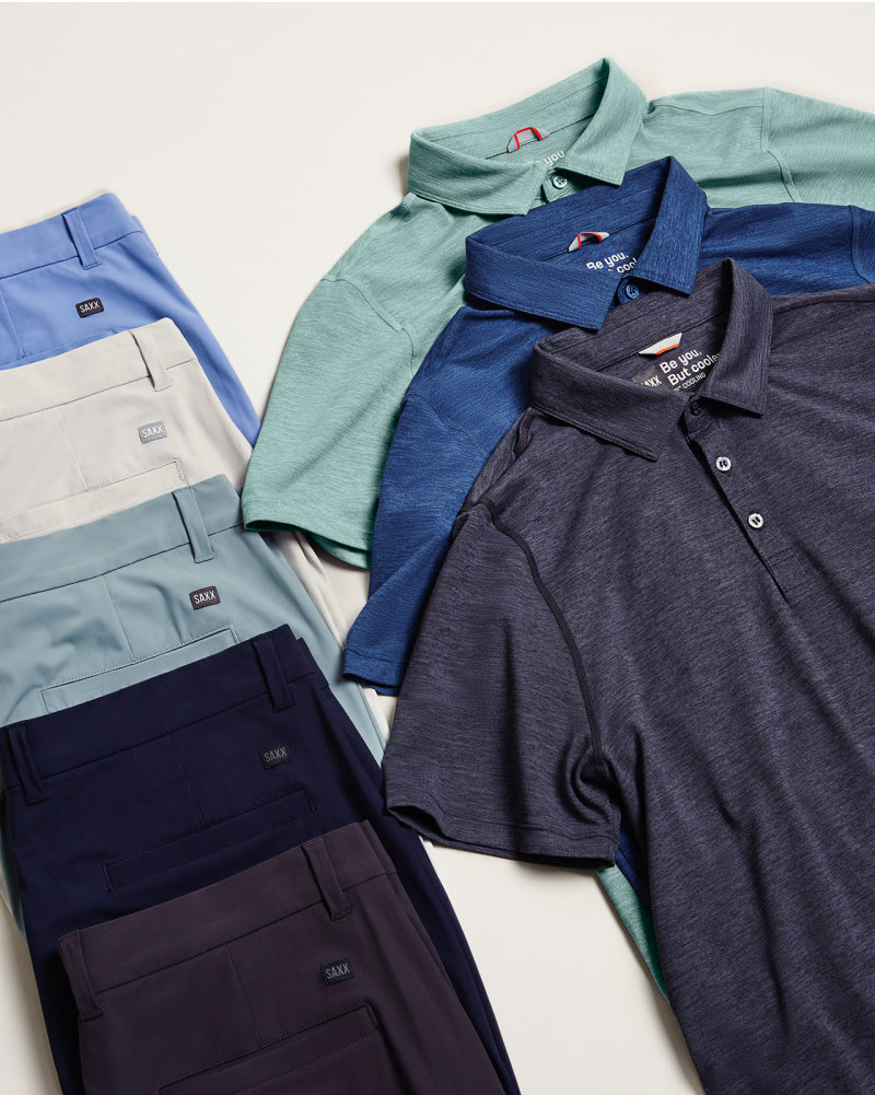 Five pairs of shorts stacked on top of each other next to three polo shirts stacked on top of each other. 