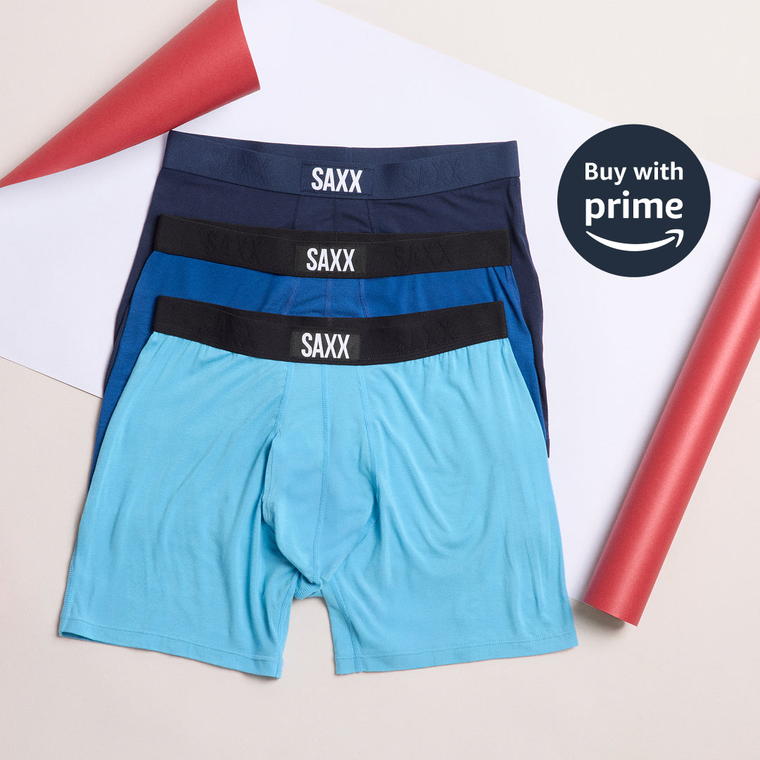 Three pairs of SAXX underwear in blue and black on a white background with 'Buy with Prime' Amazon logo.