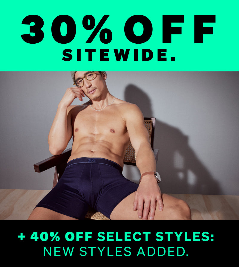 Man sitting shirtless in dark underwear with promotional text overlay on a green and black background