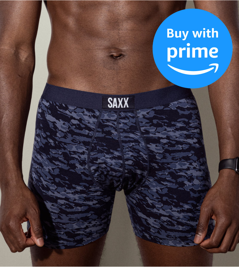 Person wearing navy camouflage SAXX underwear with a 'Buy with Prime' badge.