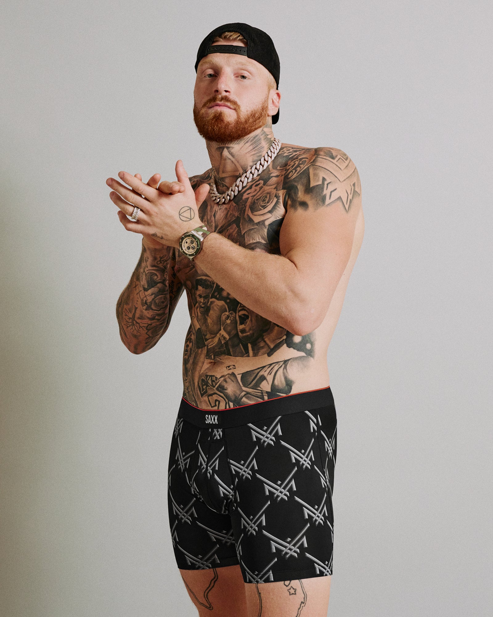 Maxx Crosby posing in his limited edition SAXX Underwear print, Multi-Sport Mesh Boxer Brief Fly in Maxx Luxx Logo-Black