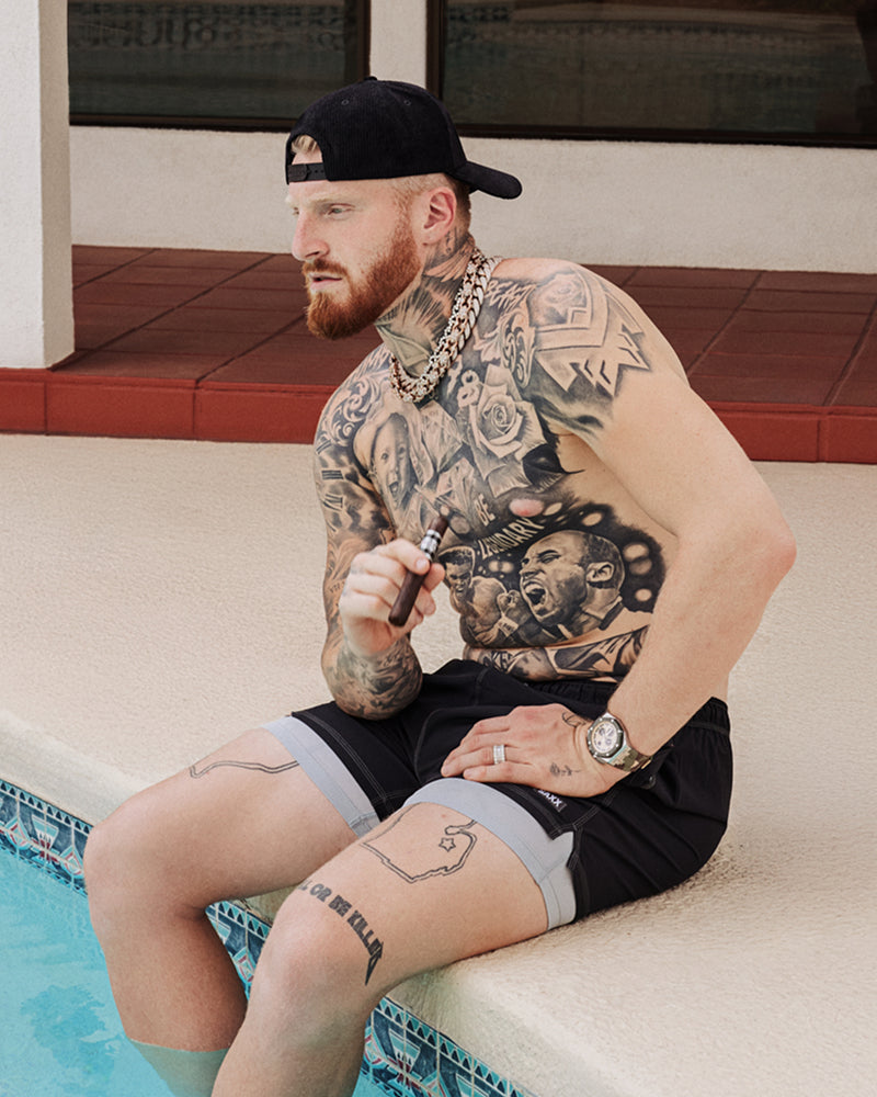 Maxx Crosby wearing Oh Buoy swim shorts poolside showing off the quick-dry fit and cooling liner technology