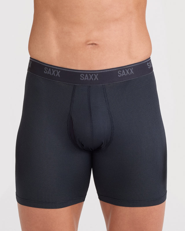 Model wearing black boxer briefs with 'SAXX' branding on a plain background