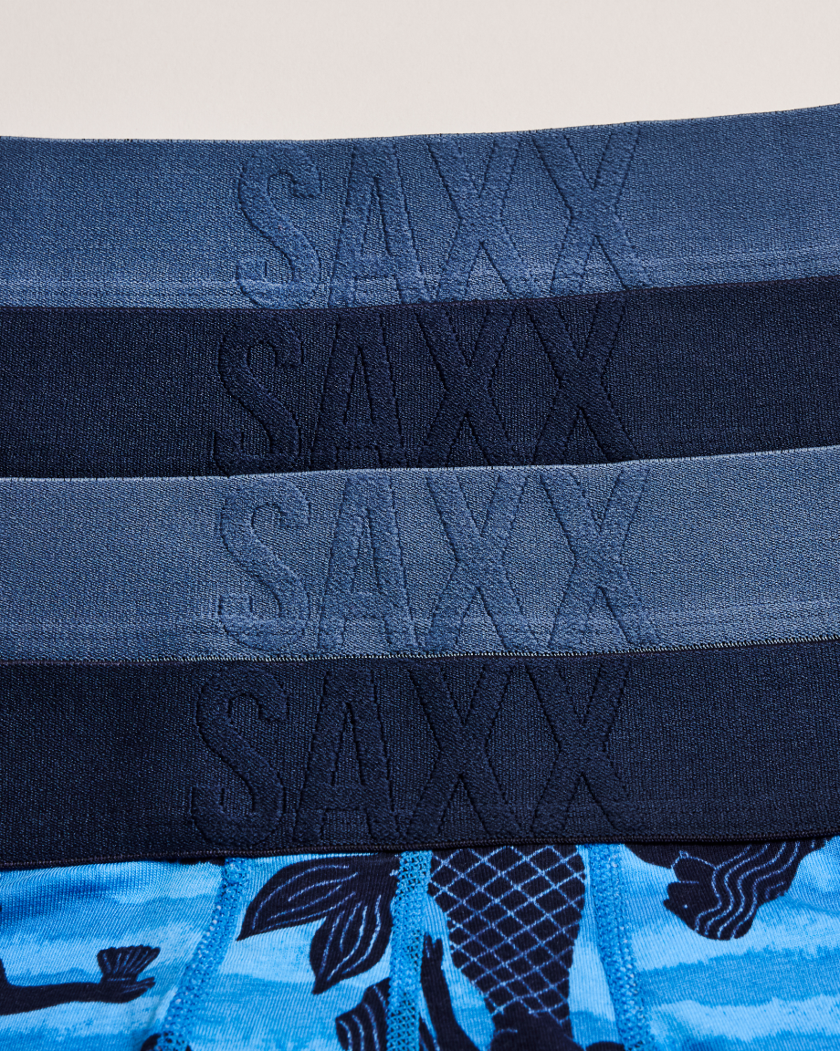 Stack of SAXX underwear with branding on a plain background