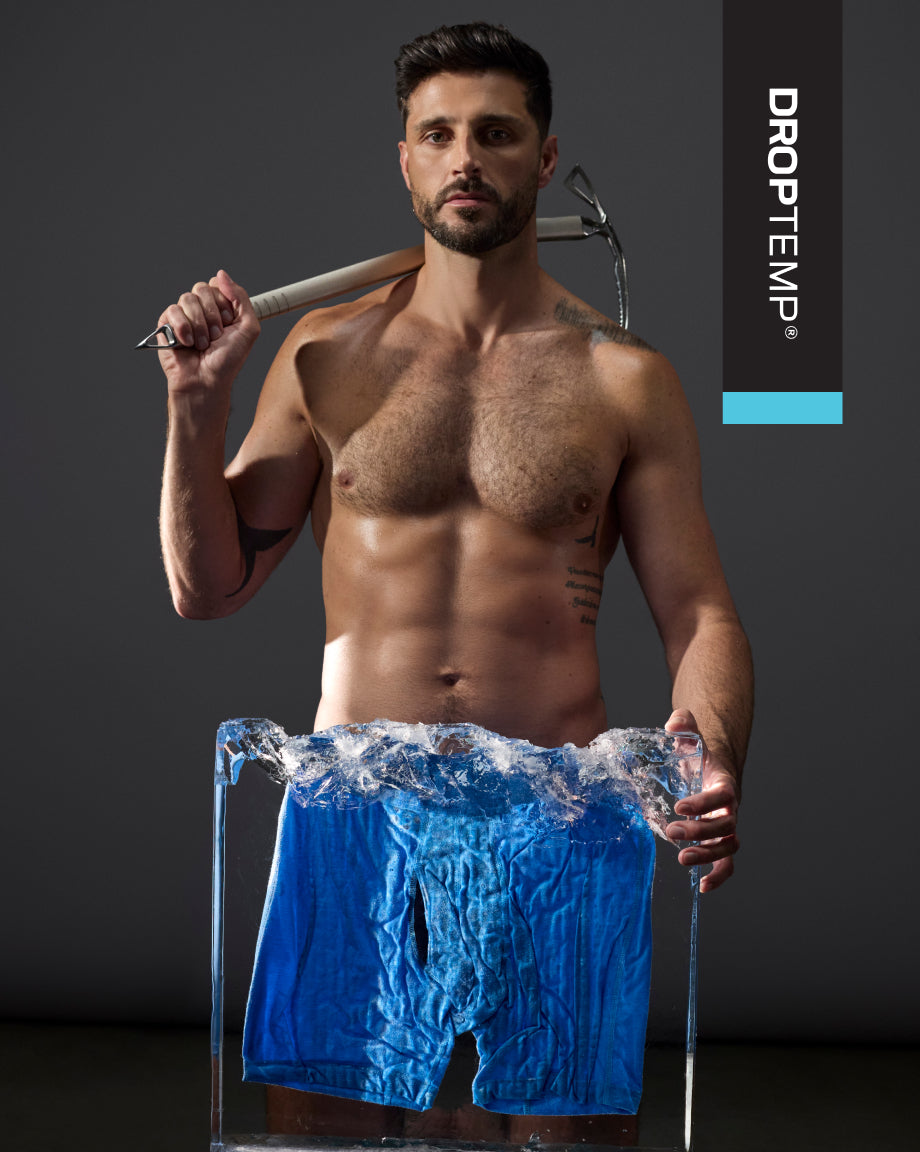 Model standing holding an ice pick in front of pair of blue underwear in block of ice with Droptemp logo in right corner