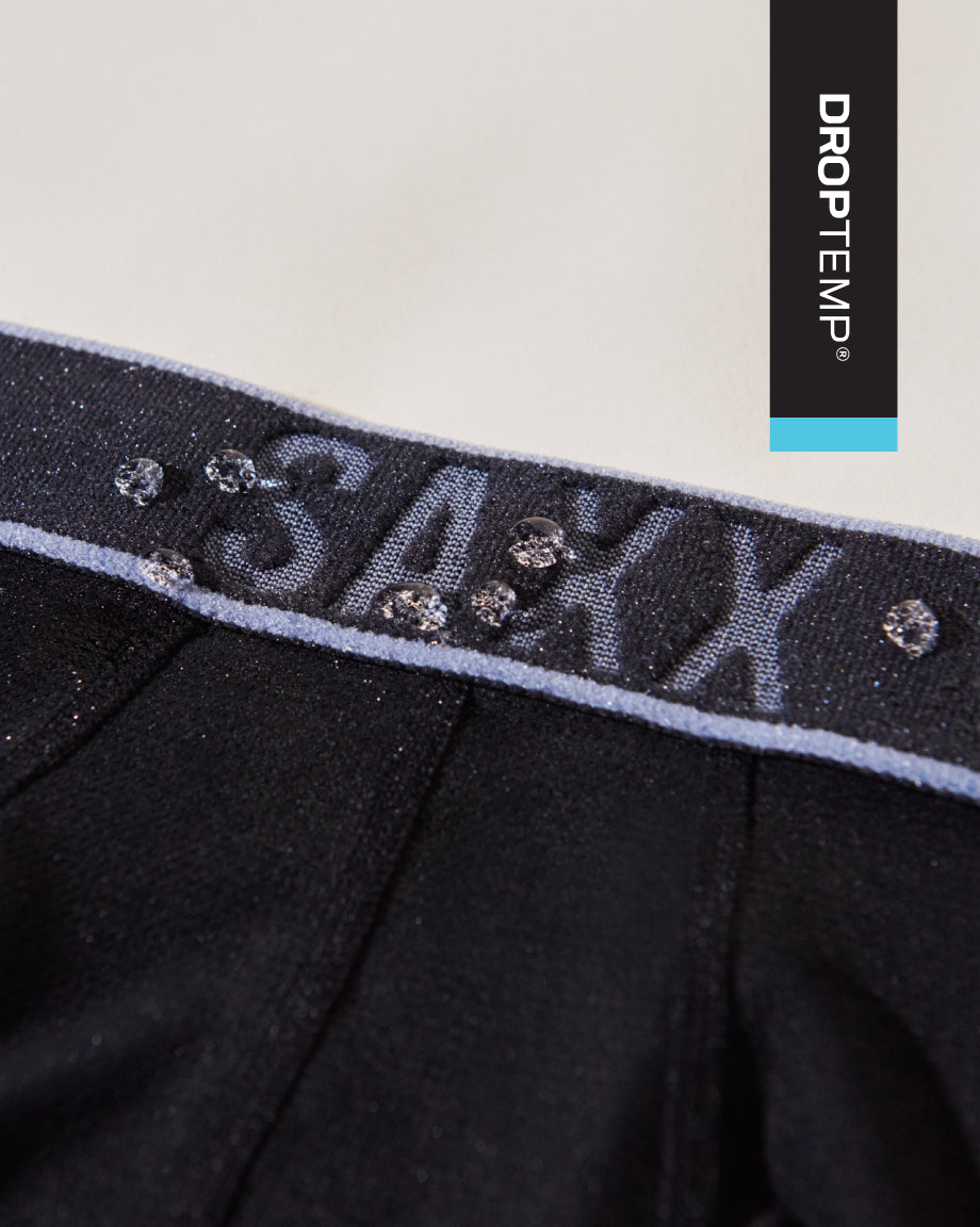 Black underwear with water drops and 'SAXX' branding on a light gray background, featuring the Droptemp logo.
