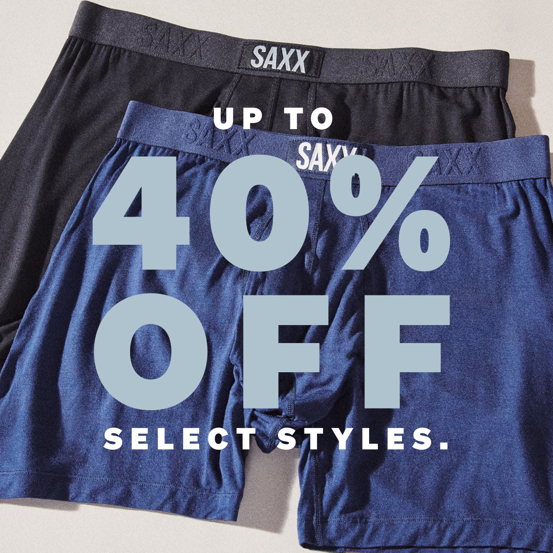 Two pairs of SAXX boxer briefs with a discount message on a light background