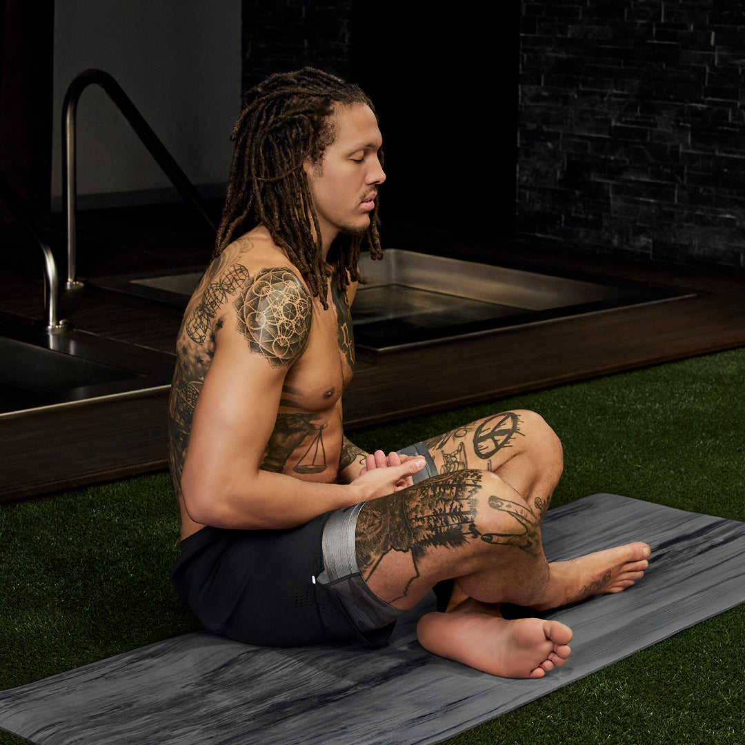 SAXX Gamechanger and Professional Basketball Player Aaron Gordon sitting on a yoga mat in a fitness space