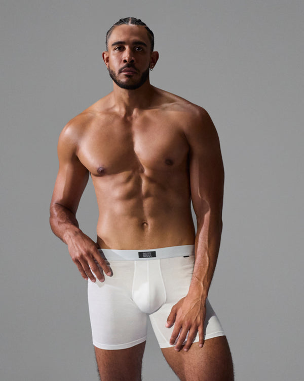 Model poses in SAXX Free 24Seven Cotton Boxer Brief in White