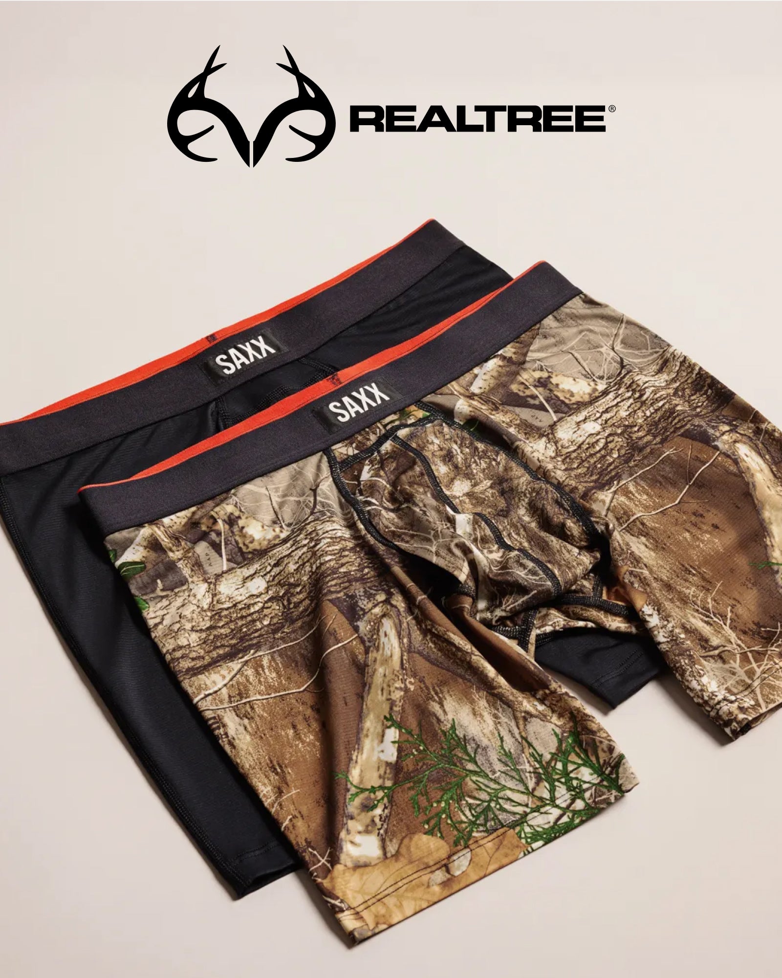Camouflage and black SAXX underwear on a beige background, featuring the Realtree logo.