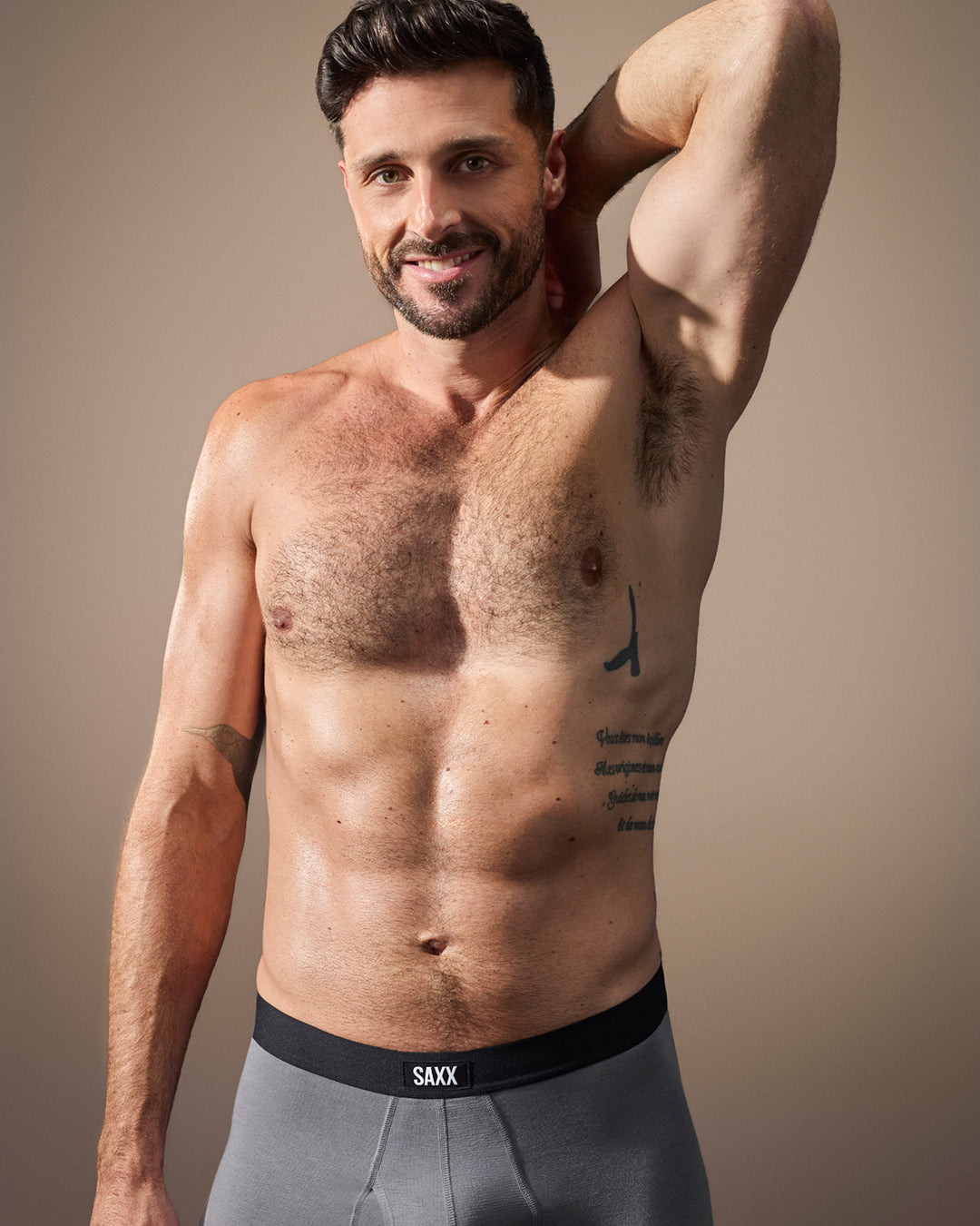 Male model wearing black SAXX underwear smiling showing supportive fit confidence and everyday comfort