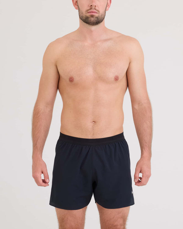 Front - Model wearing Race Pace 2N1 Run Short 5" in Black