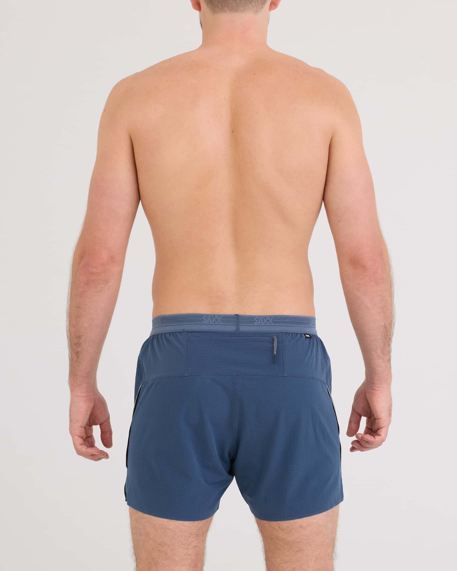 Back - Model wearing Race Pace 2N1 Run Short 5" in Washed Indigo