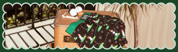 Boxer Briefs in a golf print next to golf balls and tees