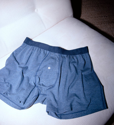 Blue sleep boxer shorts on a white armchair