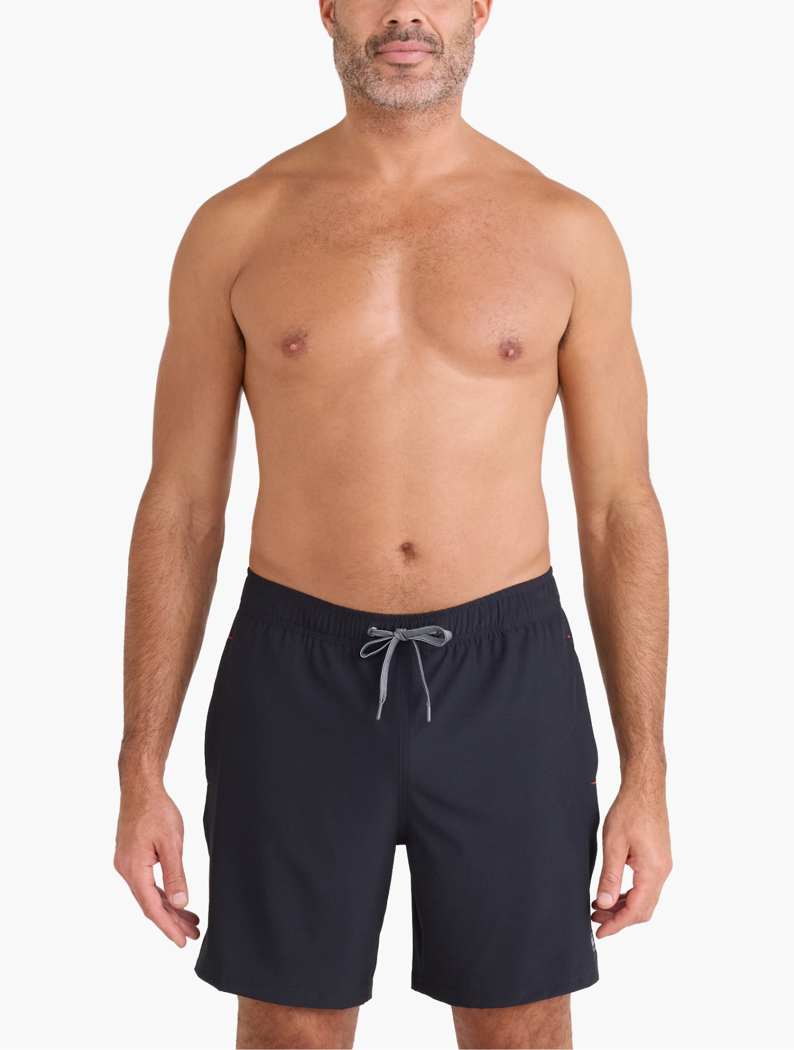 Man wearing navy swim shorts on a white background