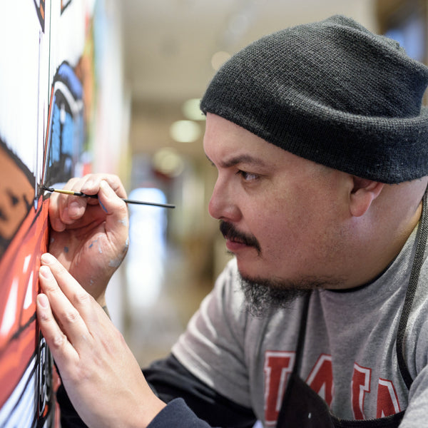 Photo of artist Daniel McCoy painting